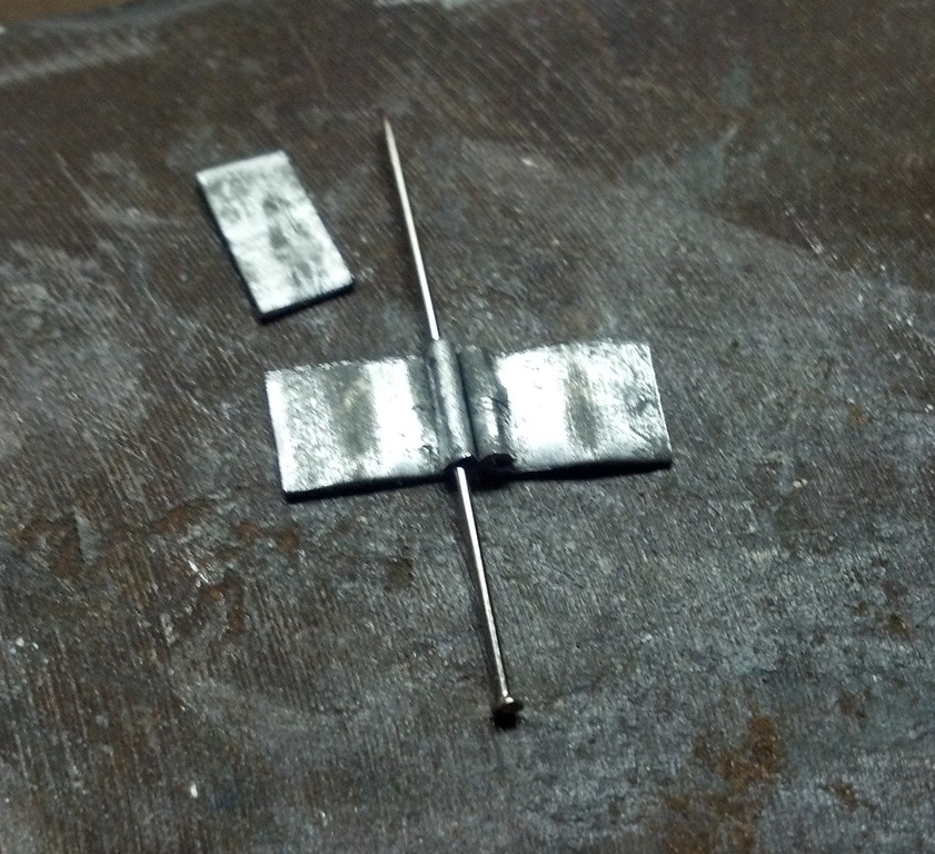 forming metal around a sewing needle to create a small cylinder
