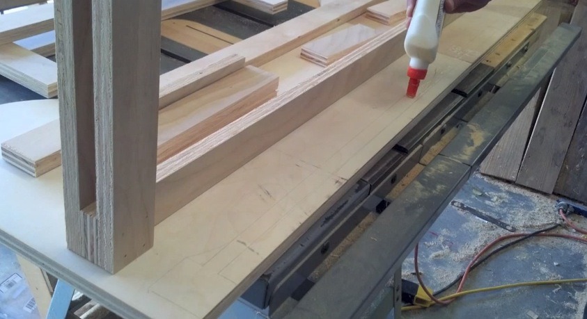 toe nailing the leg assemblies to the plywood desk top