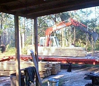 Unloading rough cut lumber with a trackhoe