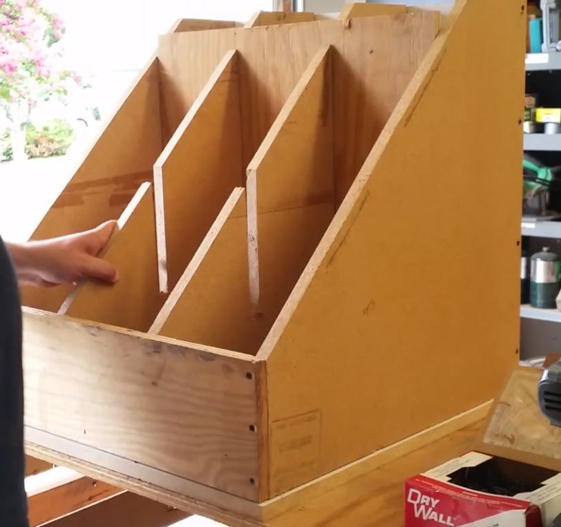 Sliding the dividers into the storage bin