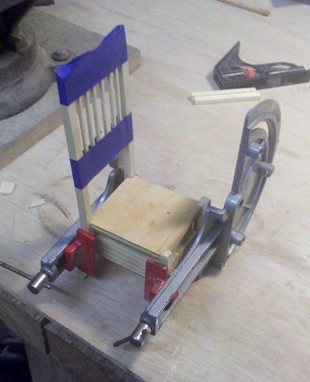 Clamping the small scale chairs while the glue dries