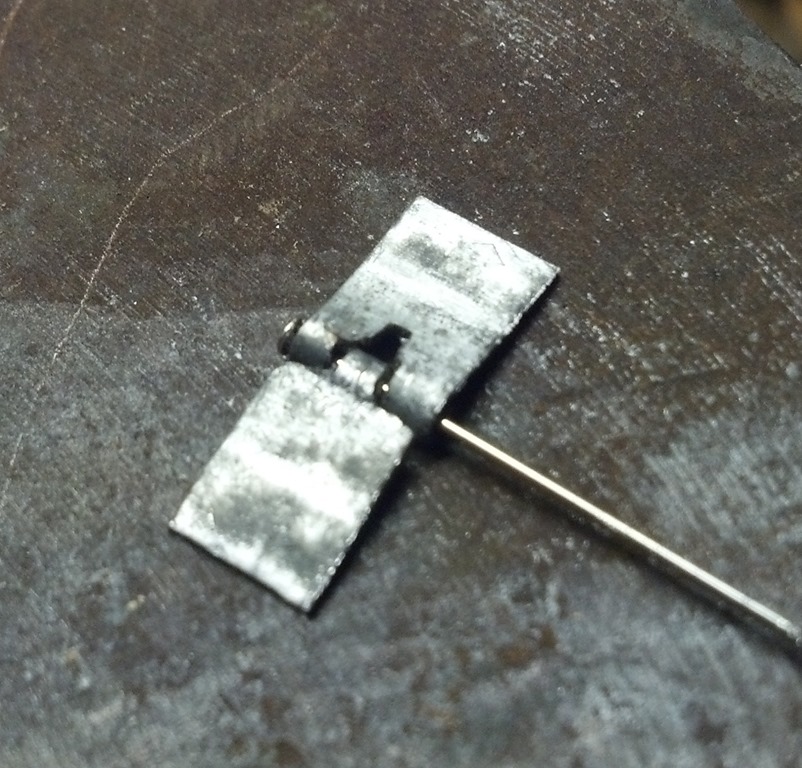 close up view of a crude scale hinge