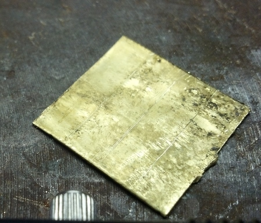squared up brass sheet marked for cutting