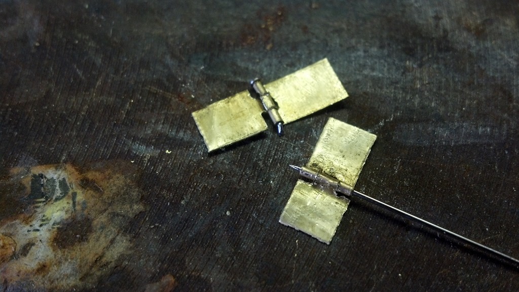 Pair of scale hinges nearly complete
