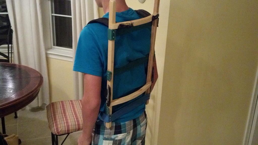 Finished wooden pack frame with gear tied on