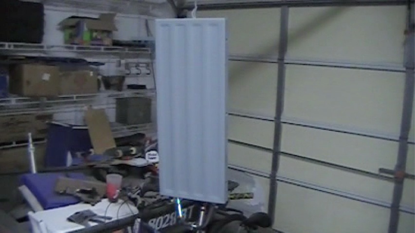 refinished metal table saw extension hanging to dry after painting
