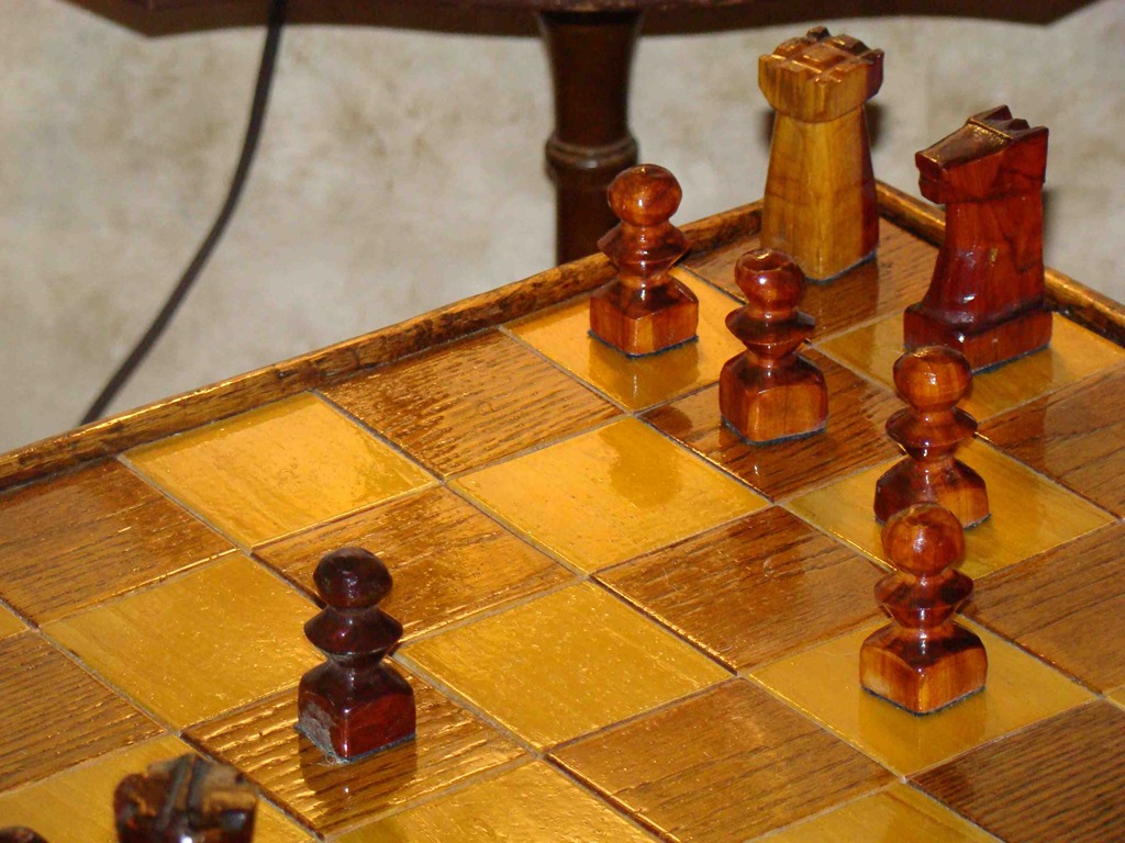 close up view of chess set and hand carved pieces